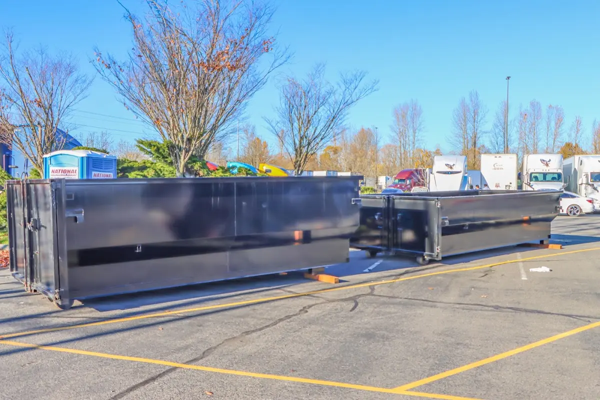 Professional dumpster rental service with roll-off container on residential driveway in Salamanca